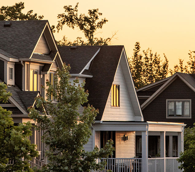 A picture taken at sunset of a blue mountain home for sale