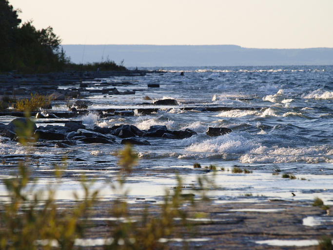 Wind-blown chop crashing onto rocky shores.